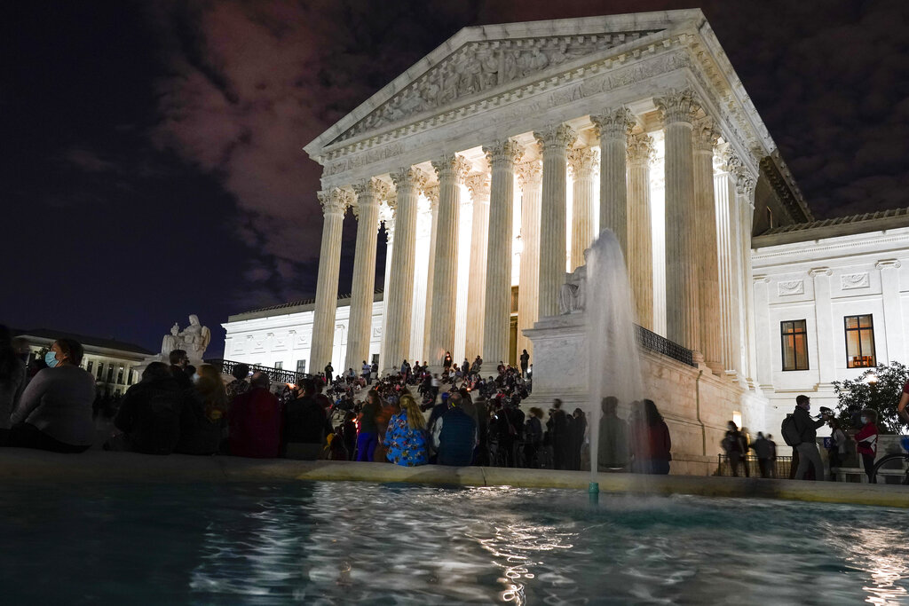 People gather at the Supreme Court on Sept. 18, 2020, after the court announced that Justice Ruth Bader Ginsburg died of metastatic pancreatic cancer at age 87. (Alex Brandon / Associated Press)