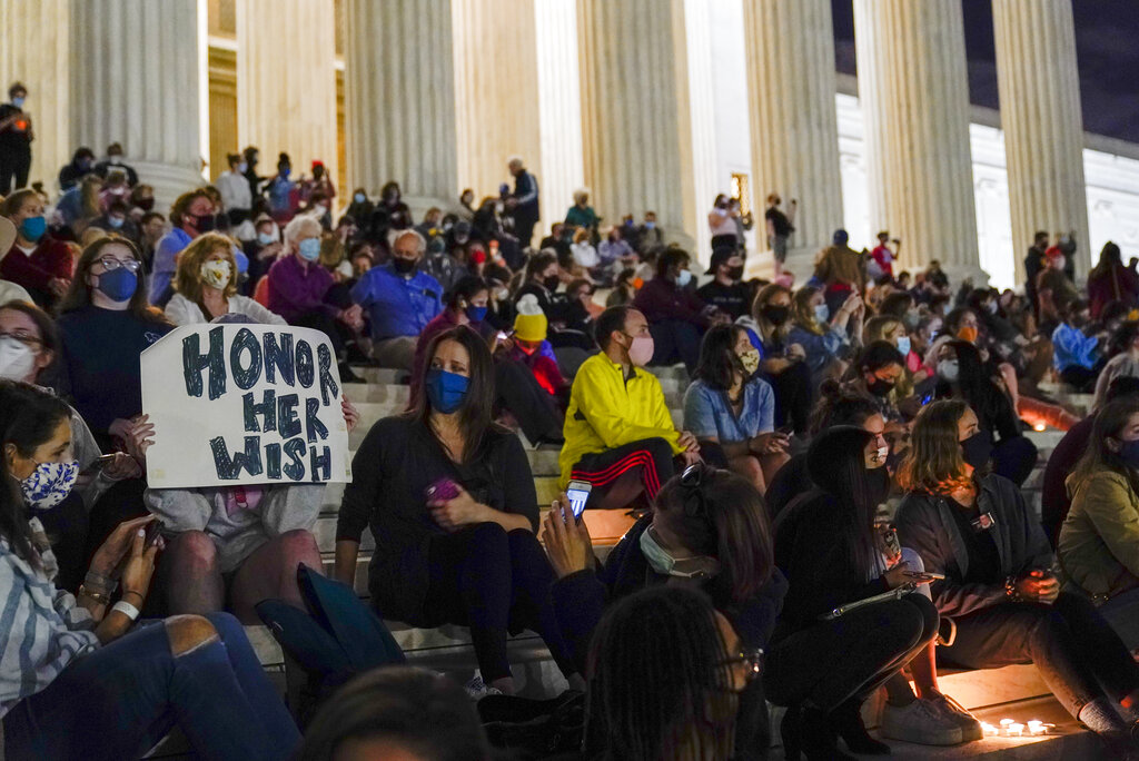 People gather at the Supreme Court on Sept. 18, 2020, after the court announced that Justice Ruth Bader Ginsburg died of metastatic pancreatic cancer at age 87. (Alex Brandon / Associated Press)