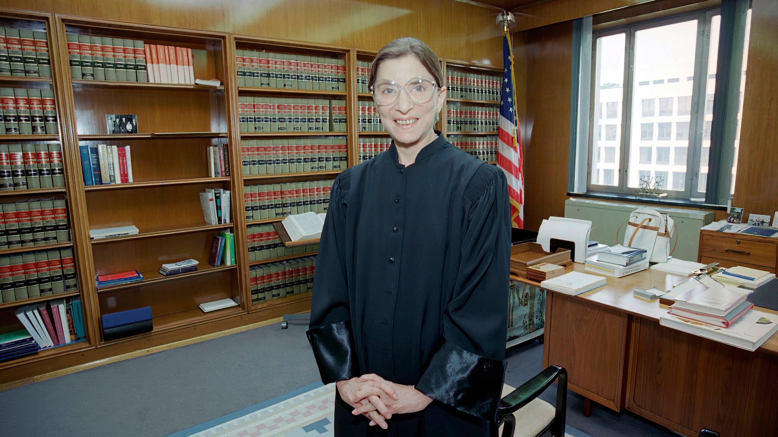 In this Aug. 3, 1993, file photo, then-Judge Ruth Bader Ginsburg poses in her robe in her office at U.S. District Court in Washington. (AP Photo/Doug Mills, File)