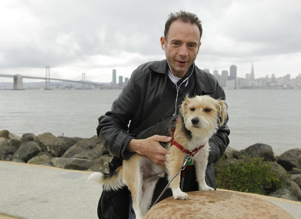 This May 16, 2011 photo shows Timothy Ray Brown with his dog, Jack, on Treasure Island in San Francisco. (AP Photo/Eric Risberg)