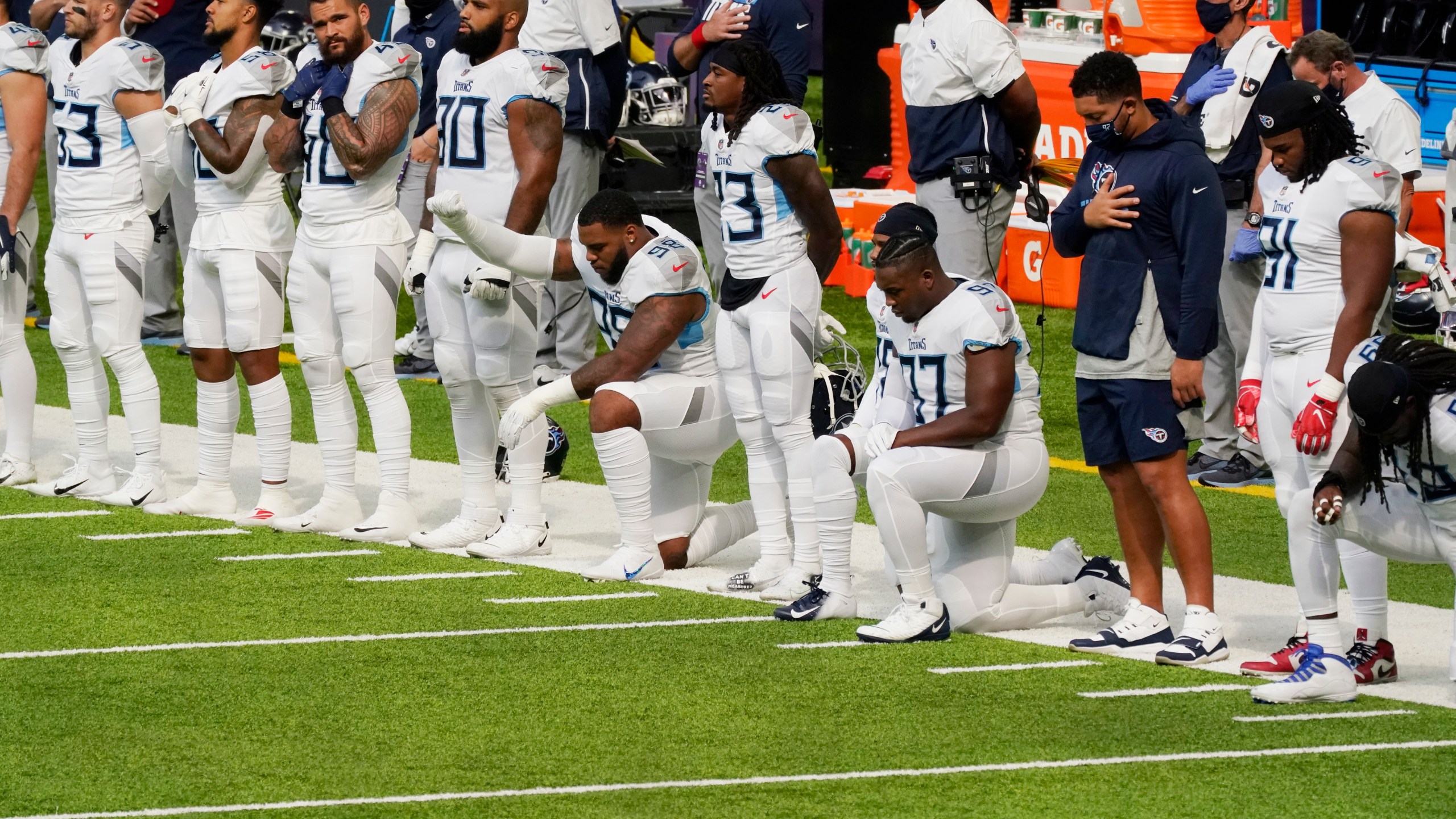 Members of the Tennessee Titans take part in the national anthem before an NFL football game against the Minnesota Vikings, Sunday, Sept. 27, 2020, in Minneapolis. The NFL says the Tennessee Titans and Minnesota Vikings are suspending in-person activities after the Titans had three players test positive for the coronavirus, along with five other personnel. The league says both clubs are working closely with the NFL and the players’ union on tracing contacts, more testing and monitoring developments. The Titans are scheduled to host the Pittsburgh Steelers on Sunday.(AP Photo/Jim Mone)