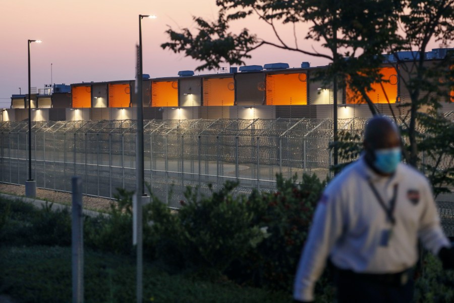 A security guard patrols outside of the Otay Mesa Correctional Facility during a "Vigil for Carlos" rally on May 9, 2020 in Otay Mesa, California. - The vigil was held to commemorate Carlos Ernesto Escobar Mejia, the first illegal immigrant who died of COVID-19 related symptoms while being held at the detention Center. (Photo by SANDY HUFFAKER / AFP) (Photo by SANDY HUFFAKER/AFP via Getty Images)