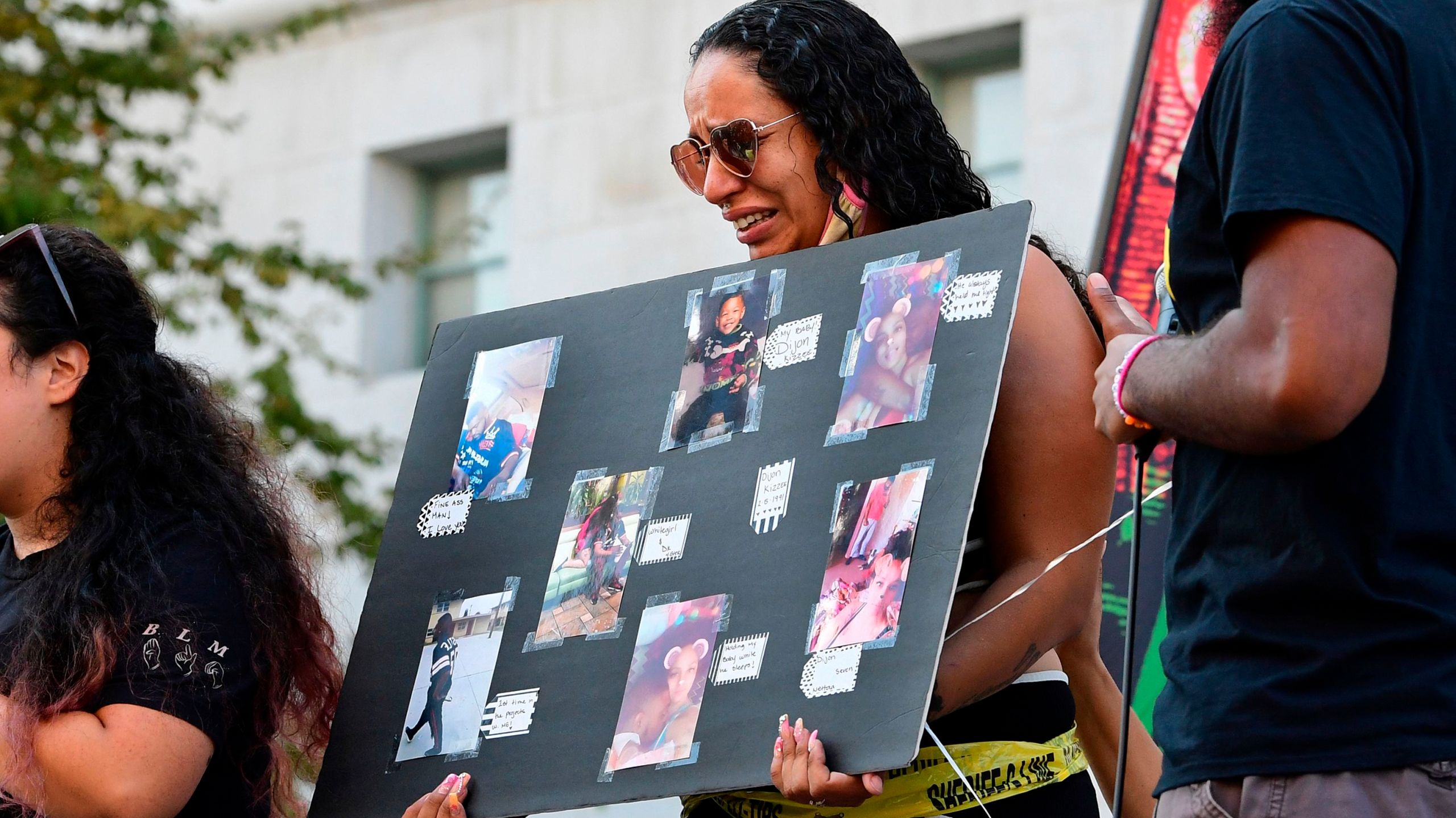 Jonetta Ewing (C), the partner of the late Dijon Kizee, who was killed by sheriff's deputies, breaks down while addressing the crowd of activists gathered for the weekly Black Lives Matter protest in front of the Hall of Justice in Los Angeles on Sept. 2, 2020. (FREDERIC J. BROWN/AFP via Getty Images)