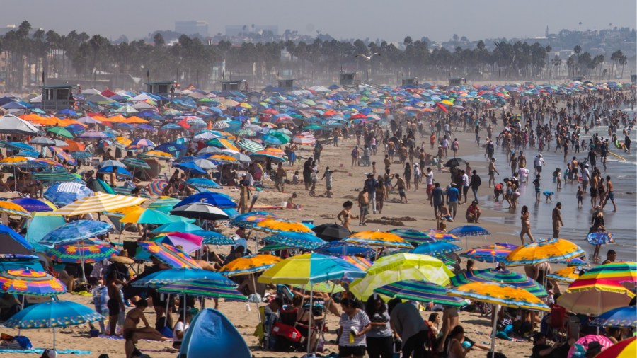 People gather on the beach on the second day of the Labor Day weekend amid a heatwave in Santa Monica on Sept. 6, 2020. (APU GOMES/AFP via Getty Images)