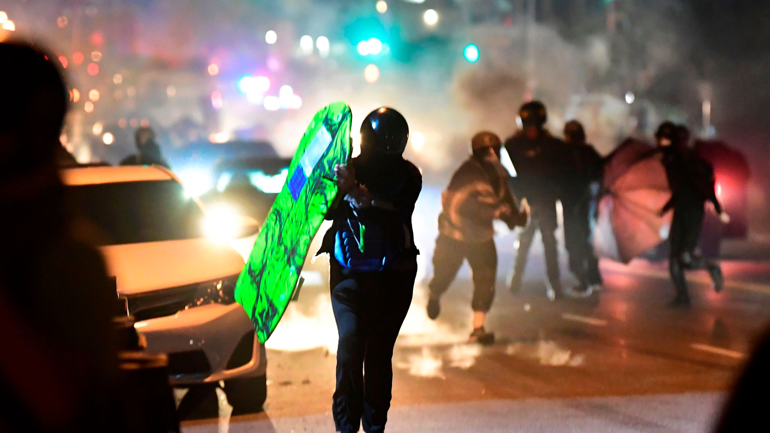 People run from tear gas and rubber bullets fired by Los Angeles County sheriff's deputies dispersing a crowd of demonstrators gathered to protest again in the wake of Dijon Kizzee's killing, outside the South LA sheriff's station on Sept. 8, 2020. (FREDERIC J. BROWN/AFP via Getty Images)