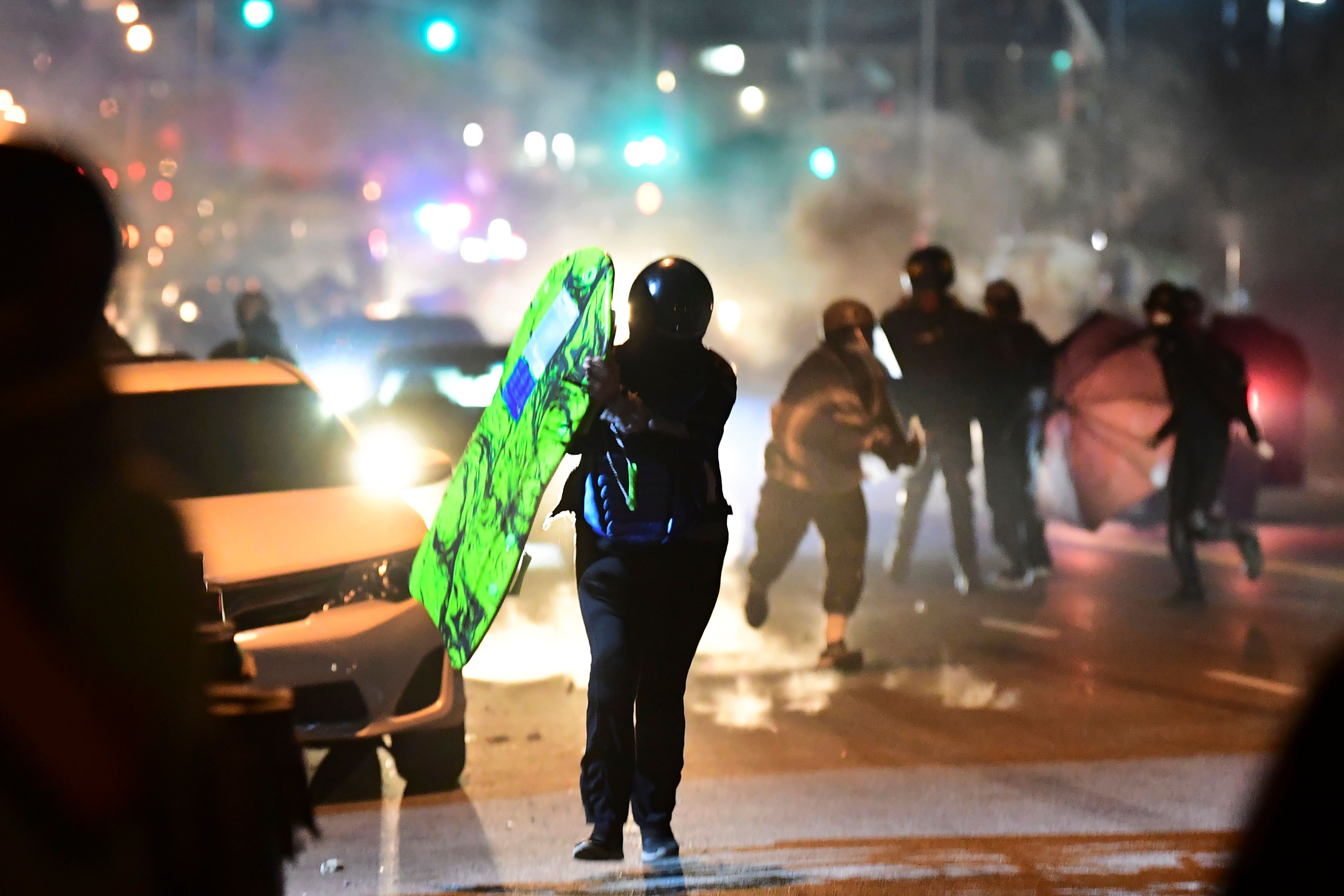 People run from tear gas and rubber bullets fired by Los Angeles County sheriff's deputies dispersing a crowd of demonstrators gathered to protest again in the wake of Dijon Kizzee's killing, outside the South LA sheriff's station on Sept. 8, 2020. (FREDERIC J. BROWN/AFP via Getty Images)