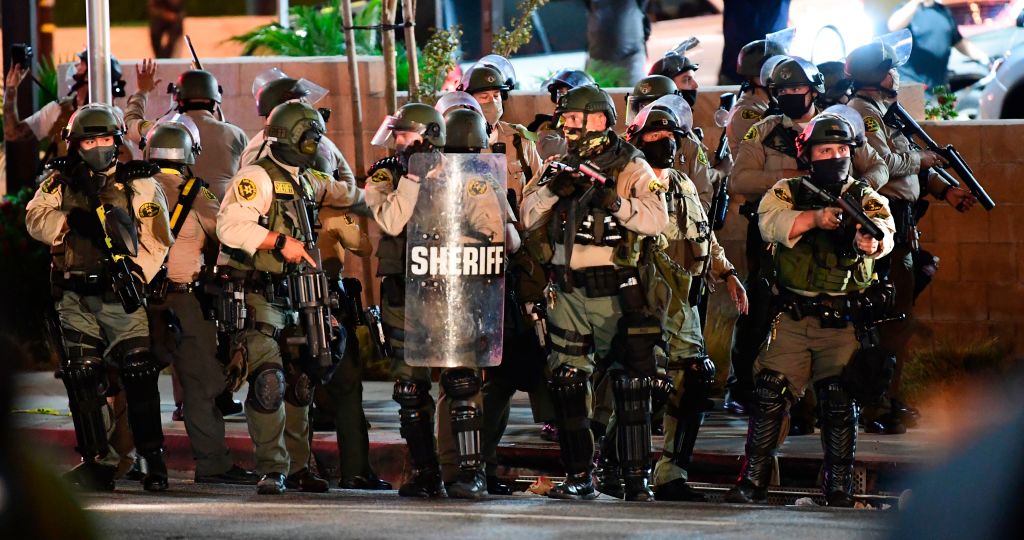 Los Angeles County sheriff's deputies ready to disperse a crowd of demonstrators gathered to protest again in the wake of Dijon Kizzee's killing, outside the South L.A. sheriff's station on Sept. 8, 2020 in Los Angeles, California. (FREDERIC J. BROWN/AFP via Getty Images)