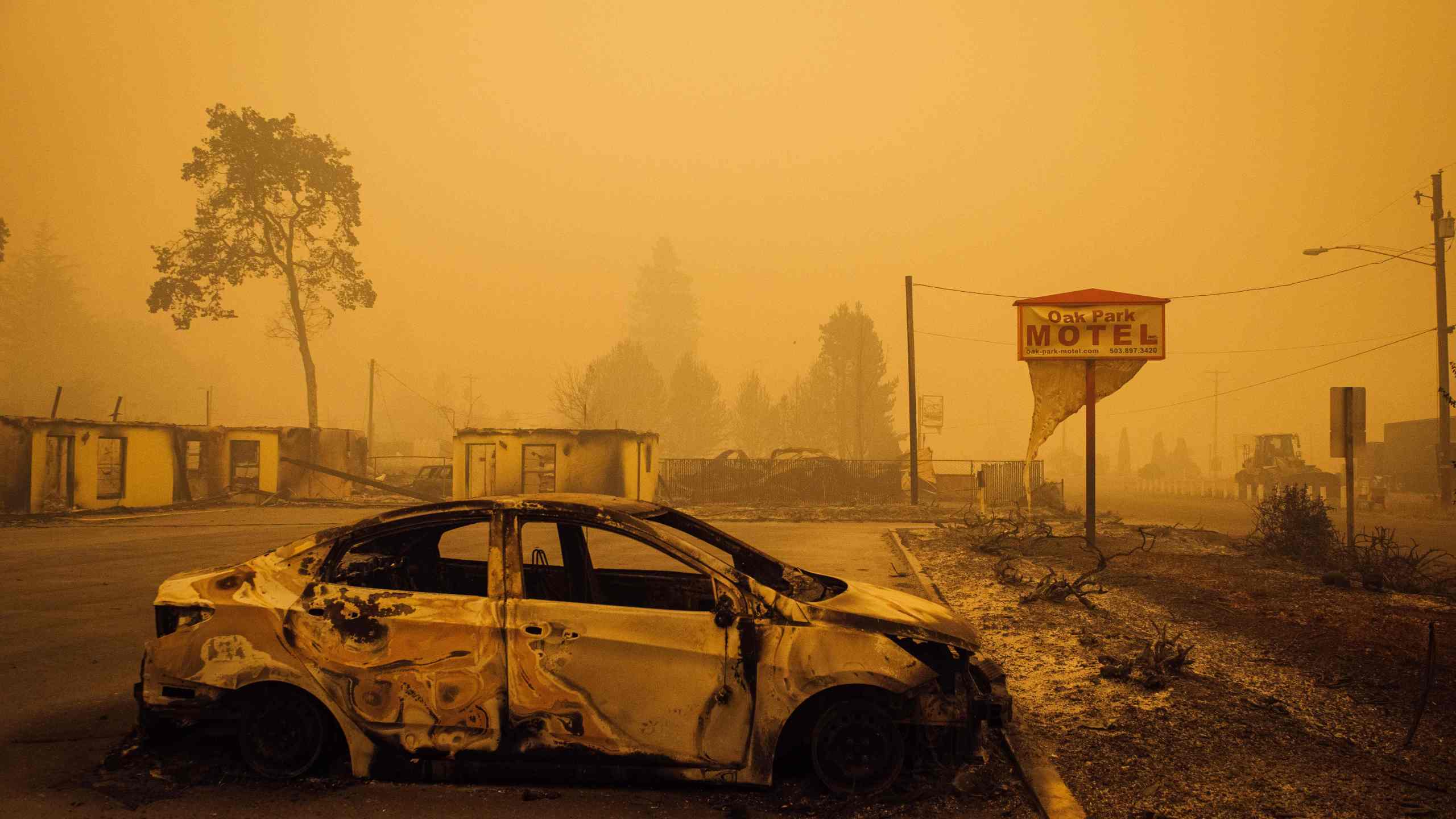 A charred vehicle is seen in the parking lot of the burned Oak Park Motel after the passage of the Santiam Fire in Gates, Oregon, on Sept. 10, 2020. (KATHRYN ELSESSER/AFP via Getty Images)