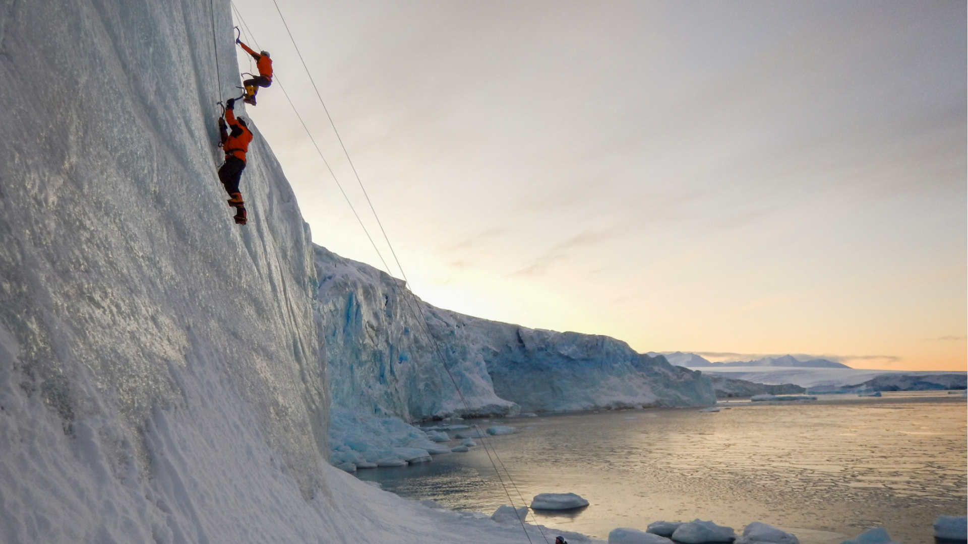 Carpenter Tom Lambert and Engineer Andy Stevenson-Jones climb ice at Hangar Cove, Rothera research station, in Antarctica on May 22, 2020. (Robert Taylor/British Antarctic Survey via AP)