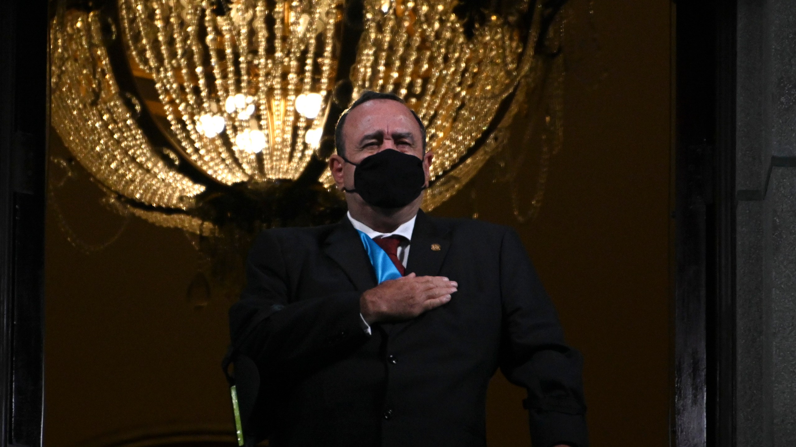 Guatemalan President Alejandro Giammattei wearing a face mask, sings the national anthem during the celebrations for the 199th anniversary of the Guatemalan independence in Guatemala City on Sept. 14, 2020. (Johan ORDONEZ/AFP via Getty Images)