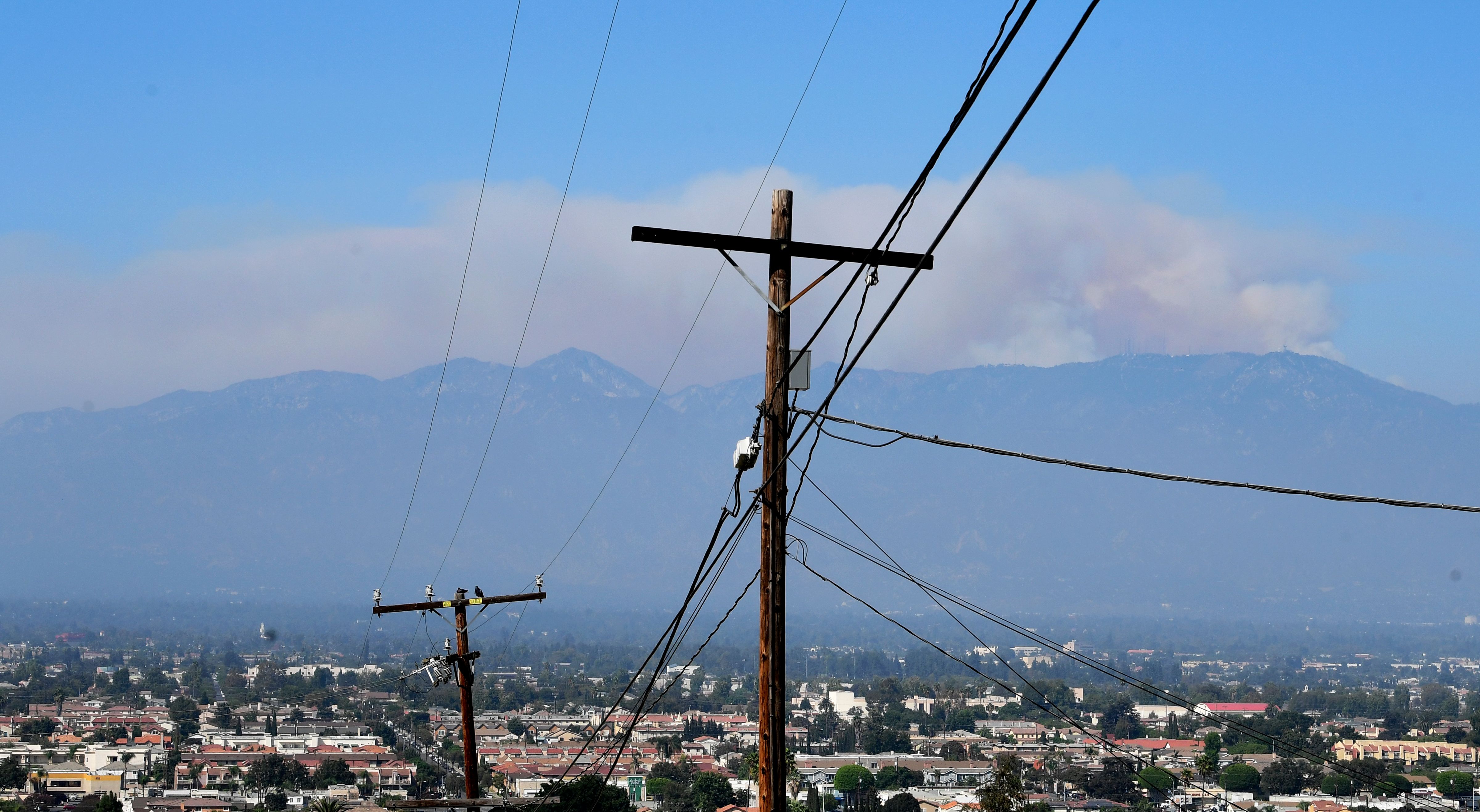 A huge plume of smoke from the Bobcat Fire rises from the Angeles National Forest over the San Gabriel Mountains as seen from Monterey Park, California on September 21, 2020. (FREDERIC J. BROWN/AFP via Getty Images)