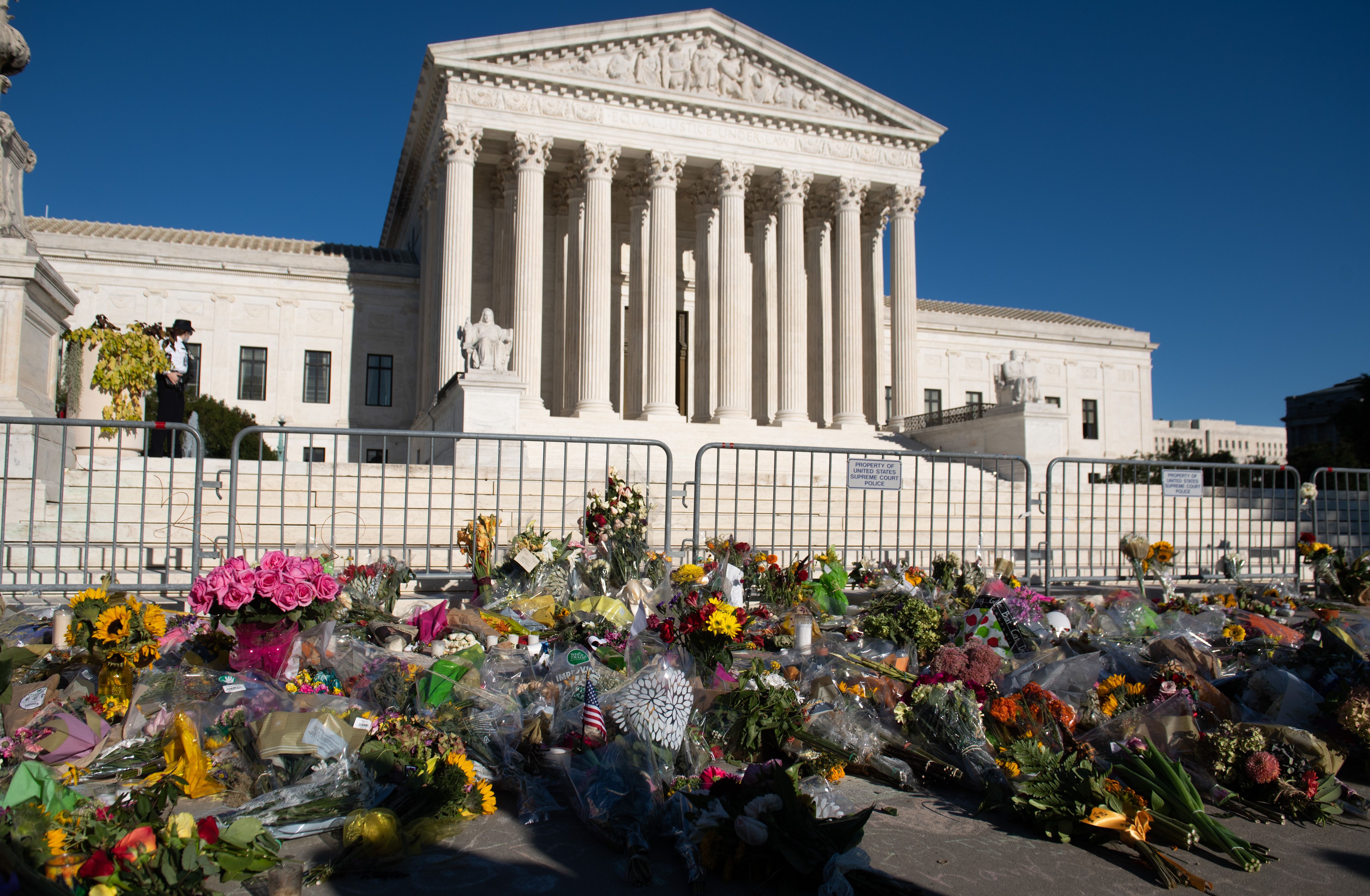 A makeshift memorial for late US Supreme Court Justice Ruth Bader Ginsburg is seen outside the US Supreme Court in Washington, DC, September 21, 2020. (Photo by SAUL LOEB/AFP via Getty Images)