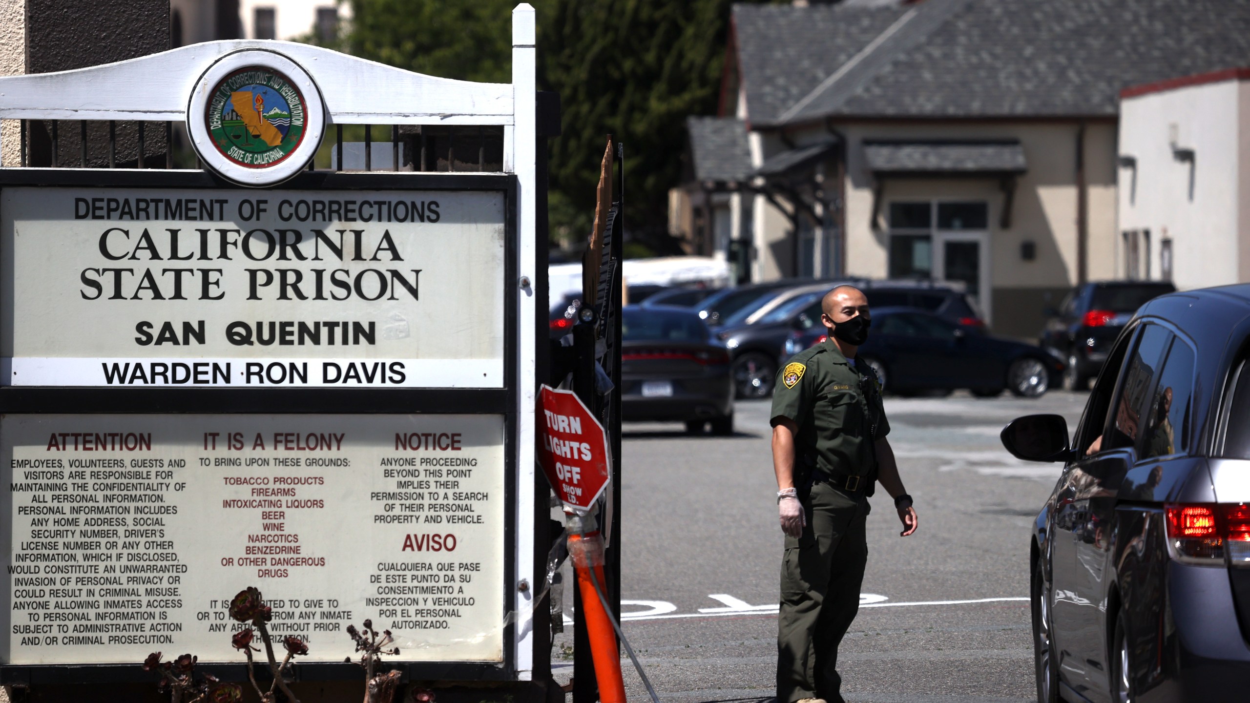 A California Department of Corrections and Rehabilitation officer wears a protective mask as he stands guard at the front gate of San Quentin State Prison on June 29, 2020, in San Quentin, California. (Justin Sullivan/Getty Images)