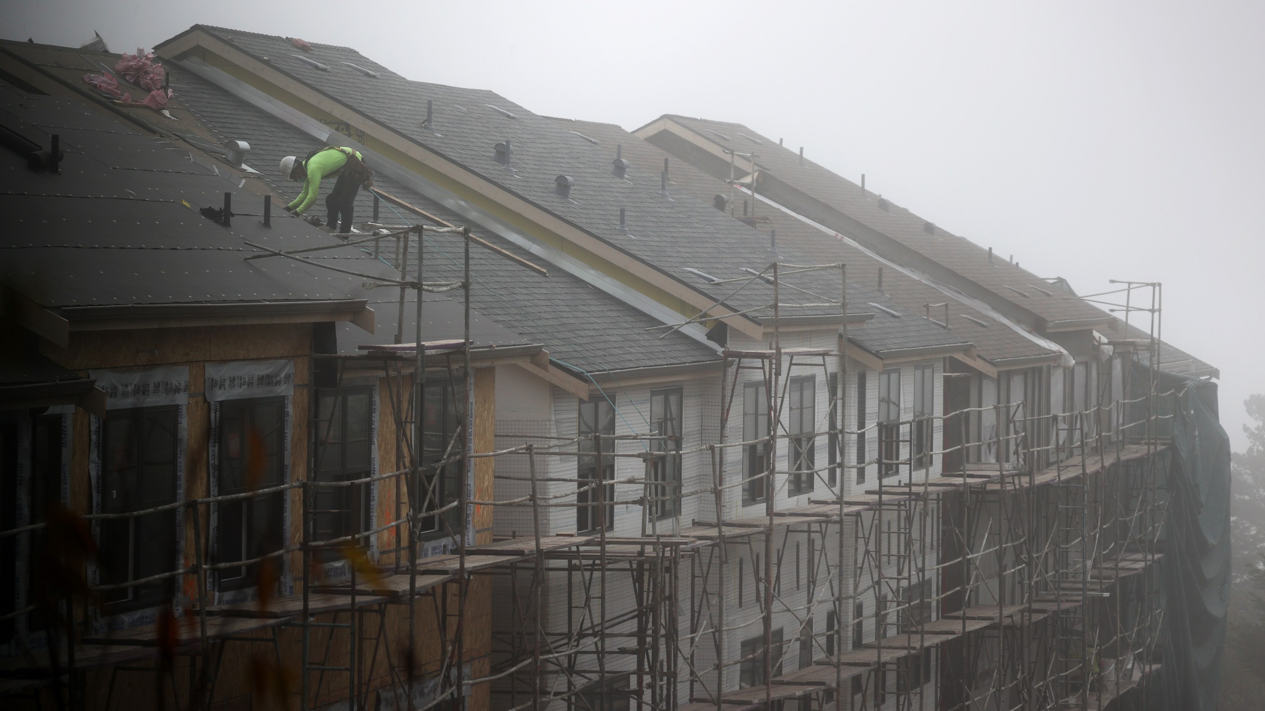 A worker stands on the roof of a new home under construction on September 24, 2020 in South San Francisco. Justin Sullivan/Getty Images)