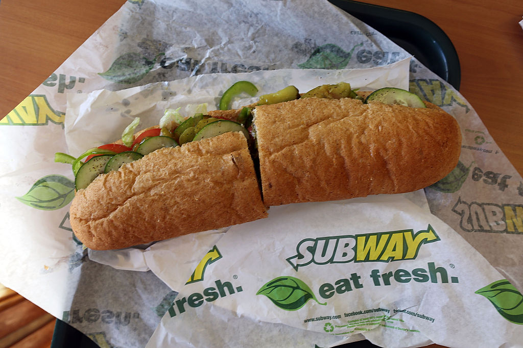 A Subway sandwich is seen in a restaurant as the company announced a settlement over a class-action lawsuit that alleged that Subway engaged in deceptive marketing for its 6-inch and 12-inch sandwiches and served customers less food than they were paying for on October 21, 2015 in Miami, Florida. (Joe Raedle/Getty Images)