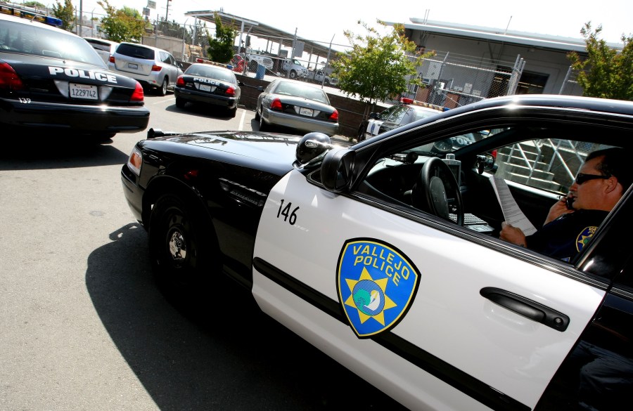 A Vallejo Police Department corporal goes over paperwork in his patrol car on May 7, 2008, in Vallejo. (Justin Sullivan / Getty Images)