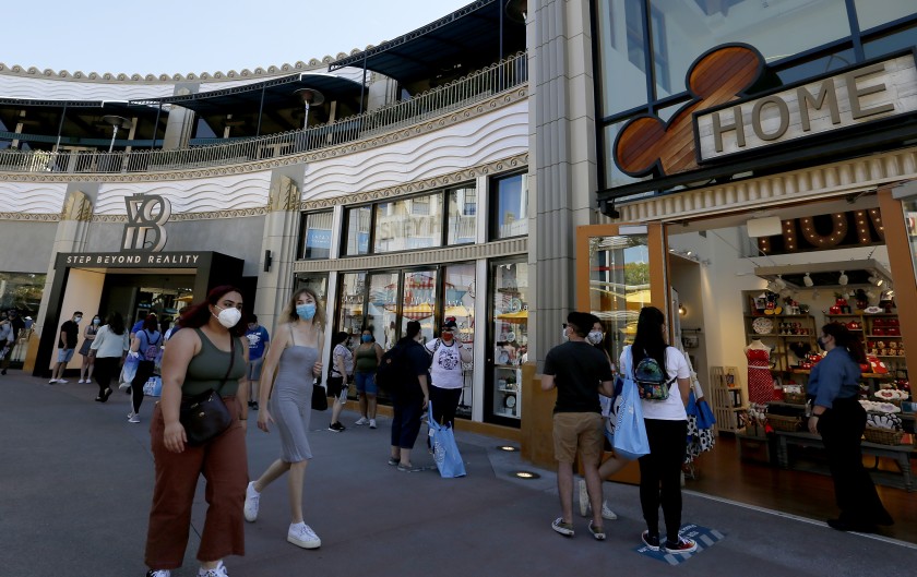 People stroll through the Downtown Disney shopping district in Anaheim in July. (Luis Sinco / Los Angeles Times)