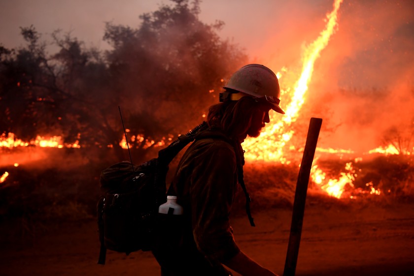 A firefighter helps to set back fires as the El Dorado fire approaches in Yucaipa, Calif., on Monday. (Wally Skalij / Los Angeles Times)