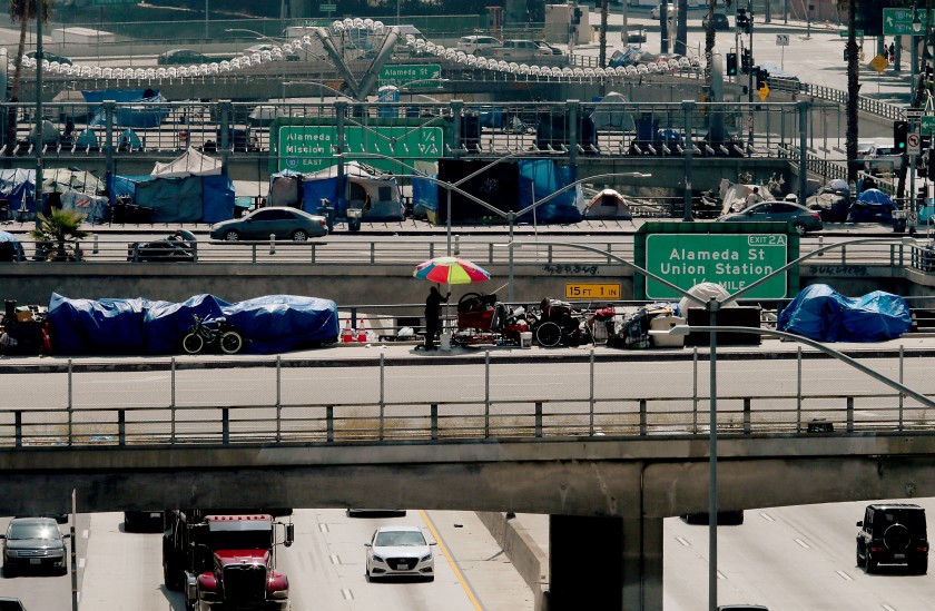 Homeless camps line Los Angeles, Main and Spring streets as they cross over the Hollywood Freeway in downtown Los Angeles.(Luis Sinco / Los Angeles Times)