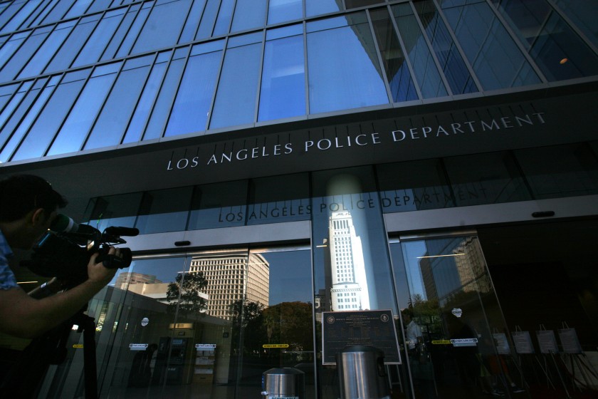 A man holds a camera outside the Los Angeles Police Department headquarters in this undated photo. (Bob Chamberlin / Los Angeles Times)