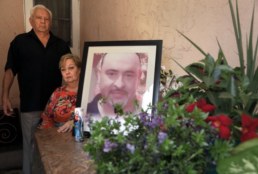 Juan and Blanca Briceno created a shrine for their son Eric Briceno, who was killed by deputies in March during what they said was a mental health call. They pose for a portrait in this undated photo. (Myung J. Chun / Los Angeles Times)