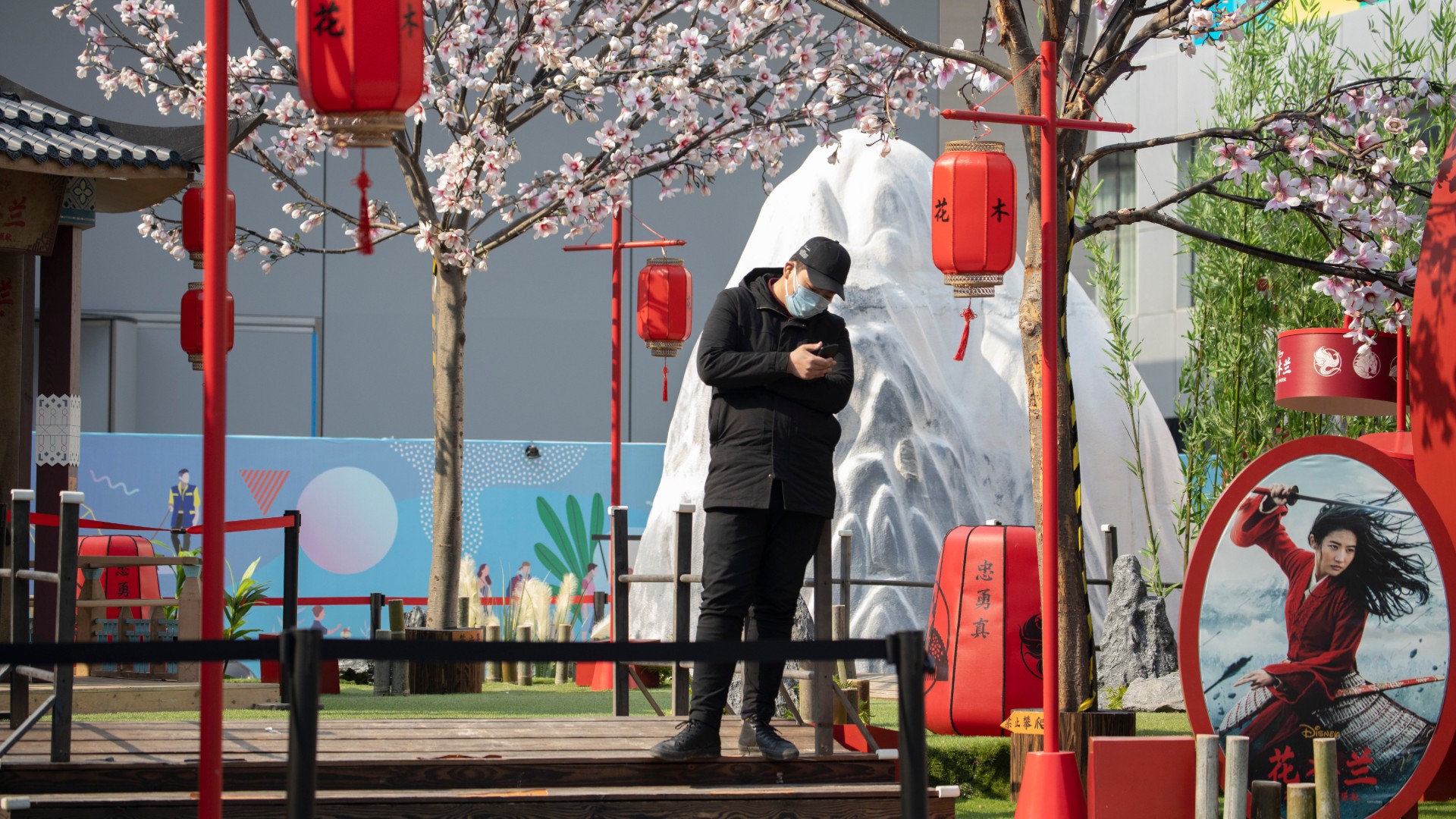 A man stands in a set promoting the Disney movie "Mulan" in Beijing on Wednesday, Feb. 19, 2020. (AP Photo/Ng Han Guan)