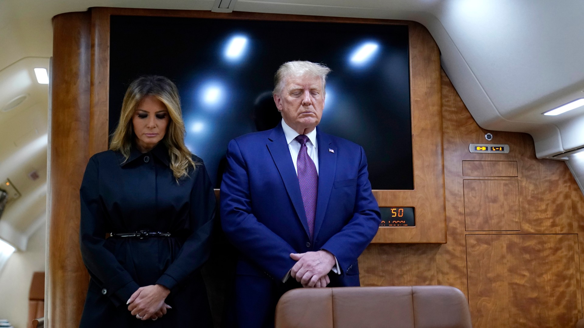 President Donald Trump and first lady Melania Trump pause for a moment of silence on Air Force One as he arrives at the airport in Johnstown, Pa., on his way to speak at the Flight 93 National Memorial, Friday, Sept. 11, 2020, in Shanksville, Pa. (AP Photo/Alex Brandon)