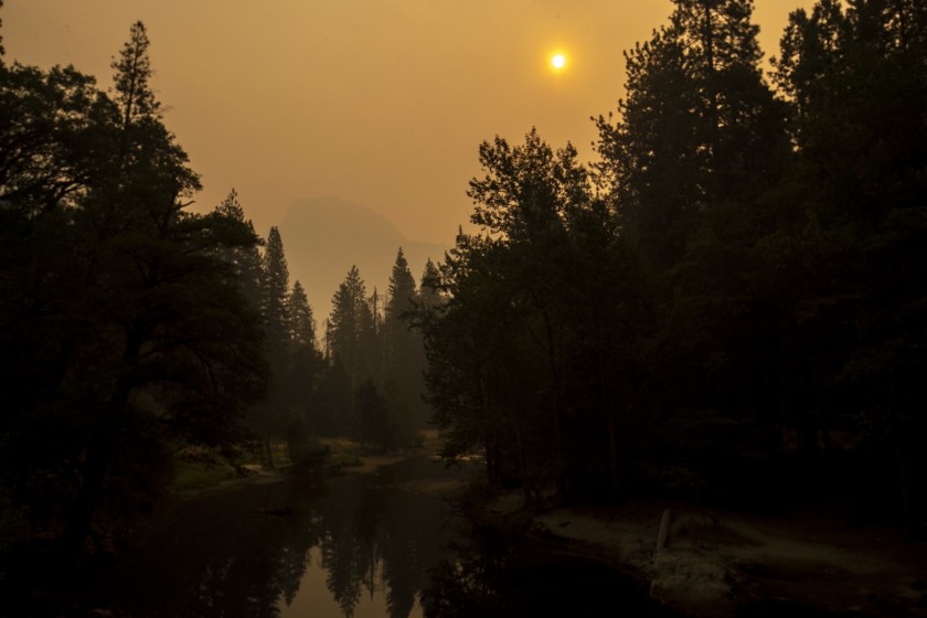 Thick smoke shrouds Half Dome over Yosemite Valley in a view from Sentinel Bridge over the Merced River on Sept. 13, 2020. (Brian van der Brug/Los Angeles Times)