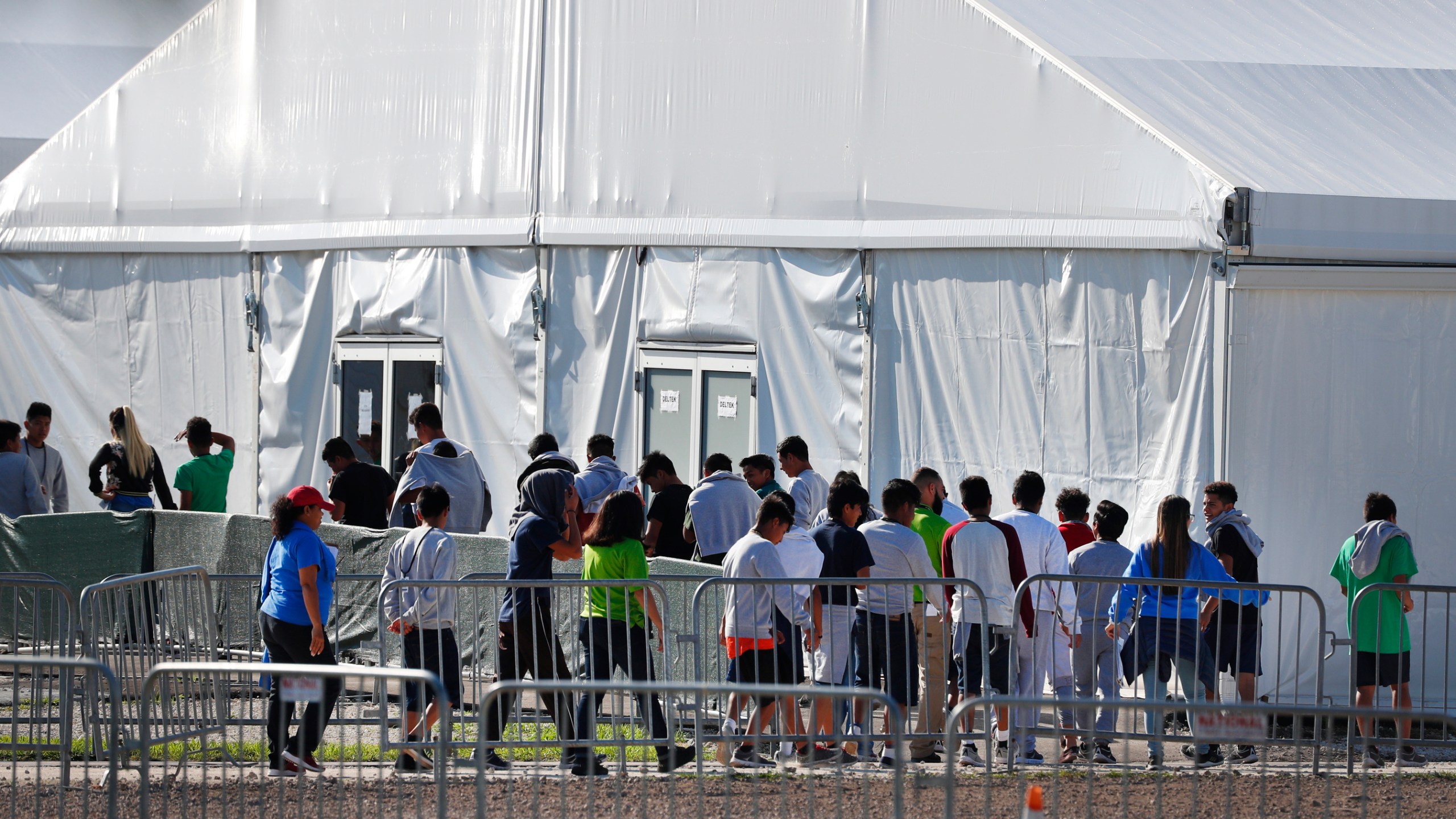 Children line up to enter a tent at the Homestead Temporary Shelter for Unaccompanied Children in Homestead, Florida, on Feb. 19, 2019. (Wilfredo Lee / Associated Press)