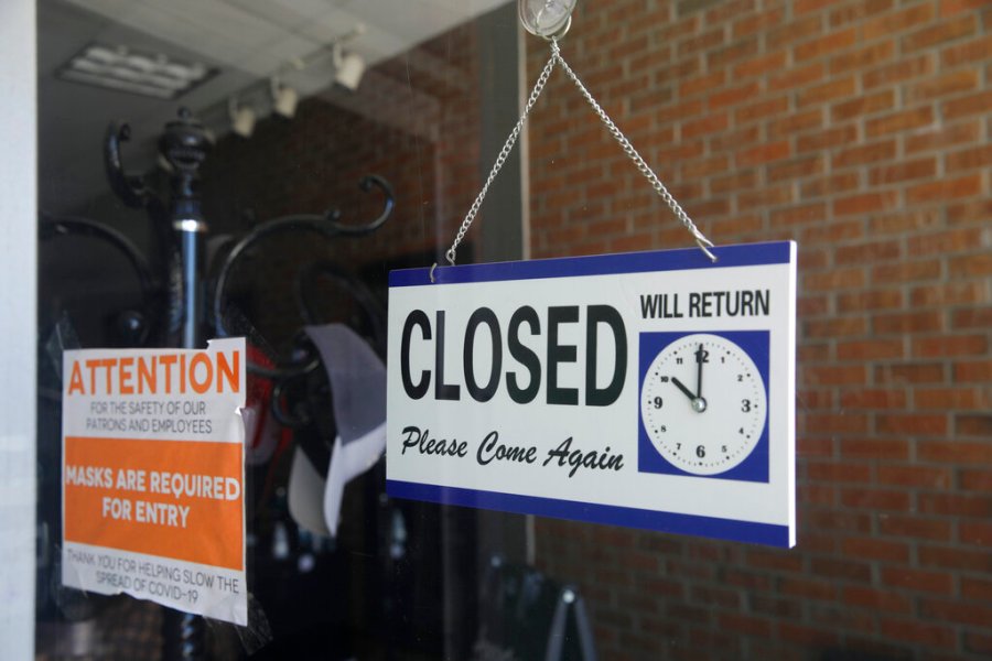 In this July 18, 2020 file photo a closed sign hangs in the window of a barber shop in Burbank, Calif. (AP Photo/Marcio Jose Sanchez, File)