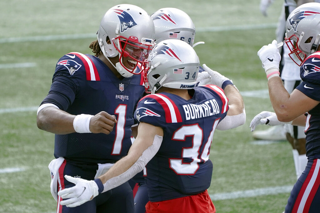 New England Patriots quarterback Cam Newton celebrates his touchdown pass to running back Rex Burkhead (34) in the first half of an NFL football game against the Las Vegas Raiders, Sunday, Sept. 27, 2020, in Foxborough, Mass. (AP Photo/Charles Krupa)