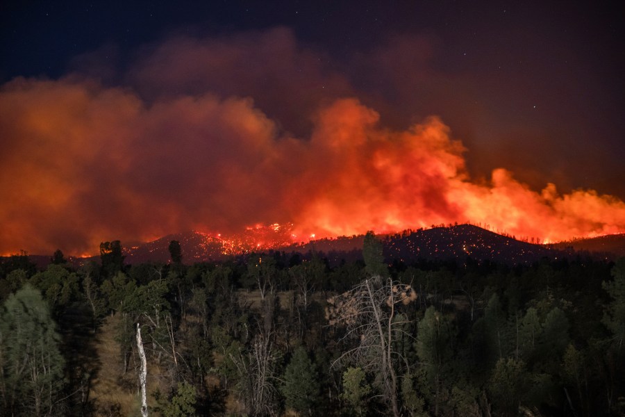 Flame are visible from the Zogg Fire on Clear Creek Road near Igo, Calif., on Monday, Sep. 28, 2020. (AP Photo/Ethan Swope)