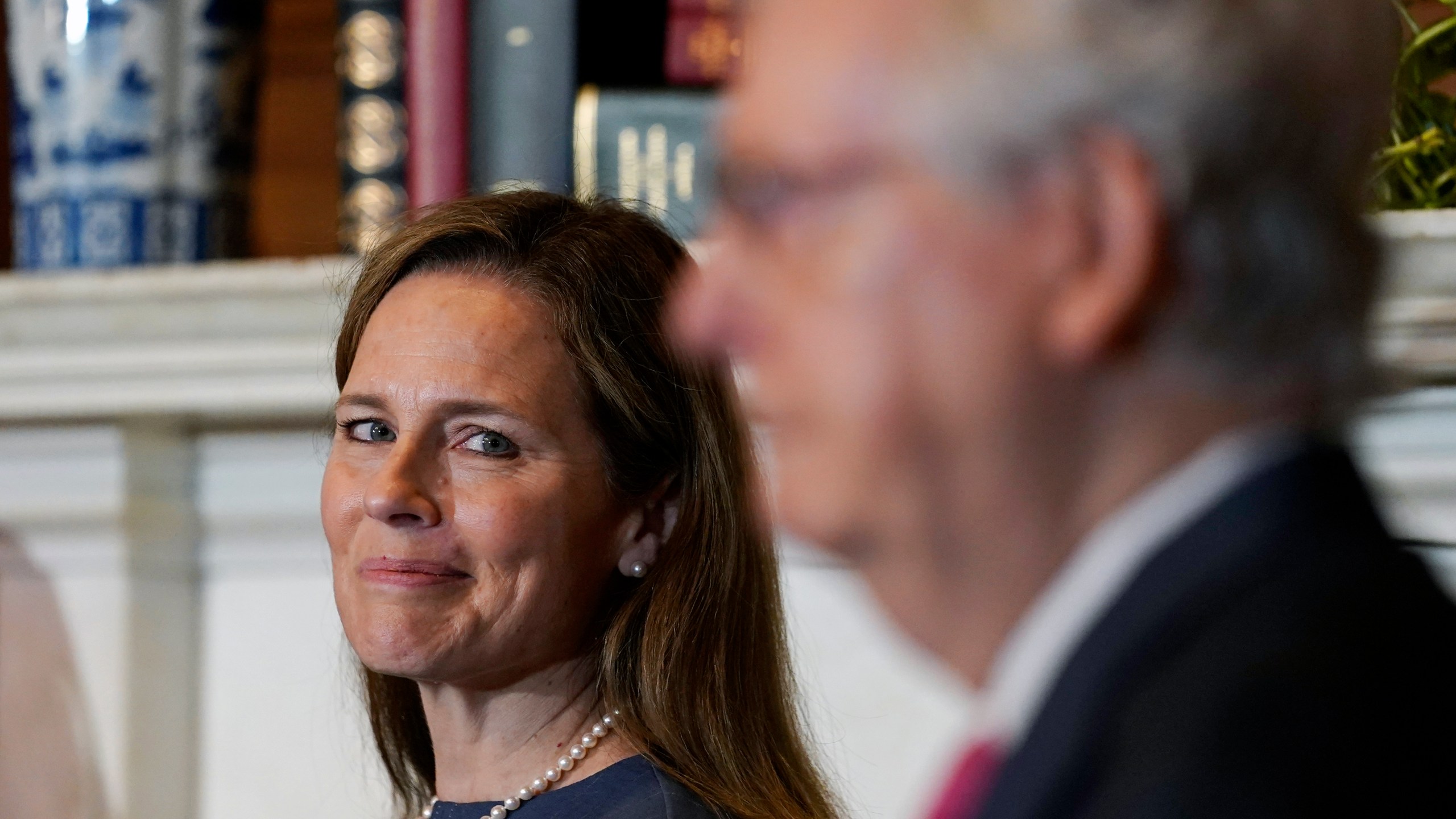 Supreme Court nominee Judge Amy Coney Barrett looks over to Senate Majority Leader Mitch McConnell of Ky., as they meet on Capitol Hill Sept. 29, 2020. Susan Walsh/Associated Press/POOL)