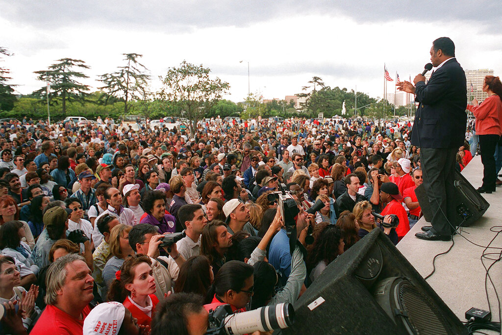 In this Oct. 27, 1996 file photo, the Rev. Jesse Jackson asks a crowd for donations to the advertising fund to stop Proposition 209 during a rally in the Westwood section of Los Angeles. Jackson was at the rally to speak out against the proposition, which he said would hurt women and people of color. In November 2020, a California with vastly different political preferences and demographics will consider repealing a 1996 law barring state and local governments from discriminating against or granting preferential treatment to people based on race, ethnicity, national origin or sex. (AP Photo/Rene Macura, File)