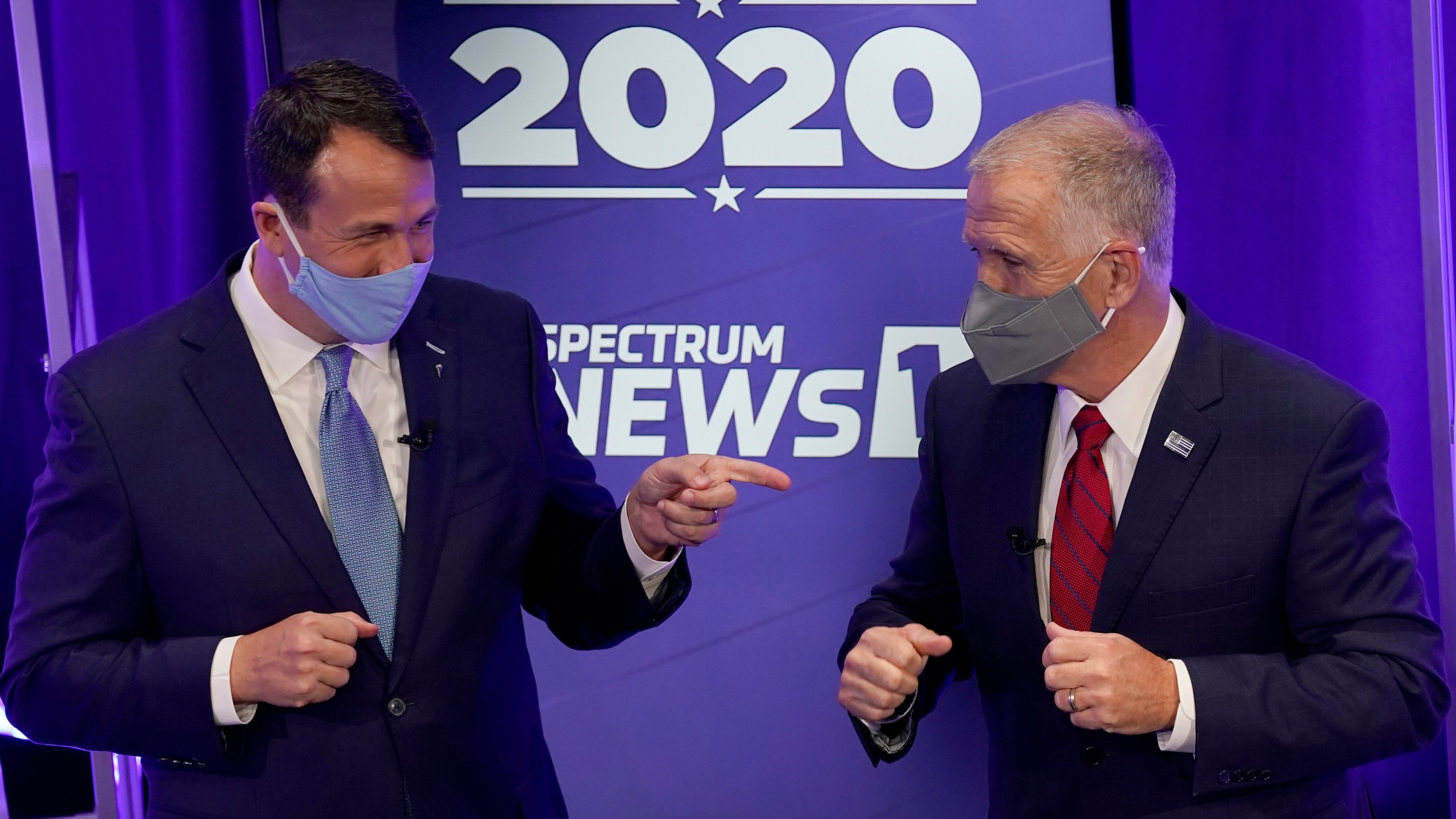 Democratic challenger Cal Cunningham, left, and U.S. Sen. Thom Tillis, R-N.C. greet each other after a televised debate Thursday, Oct. 1, 2020 in Raleigh, N.C. (AP Photo/Gerry Broome, Pool)