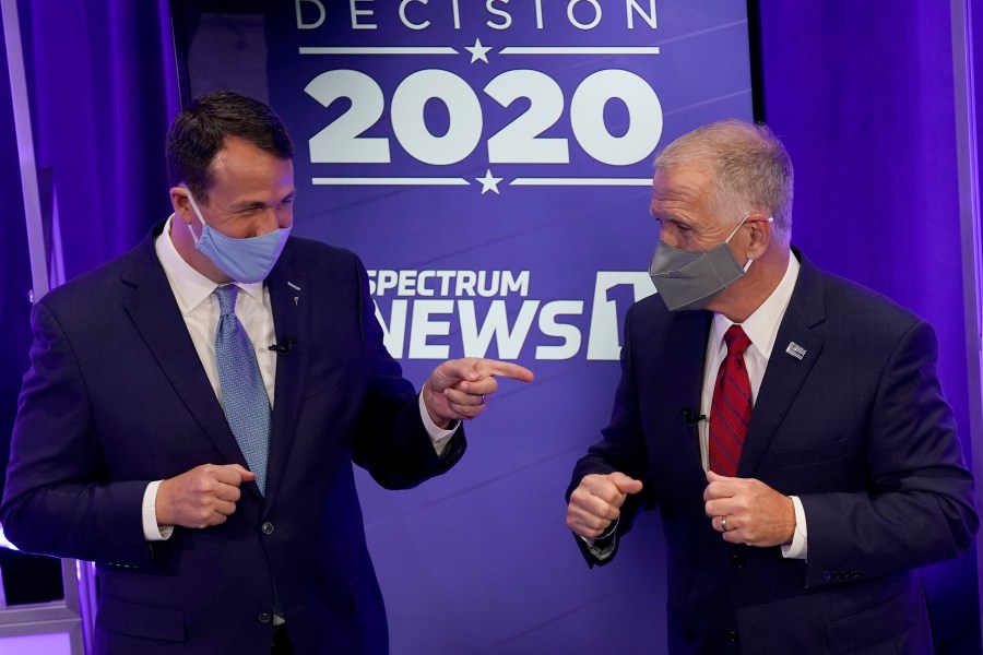 Democratic challenger Cal Cunningham, left, and U.S. Sen. Thom Tillis, R-N.C. greet each other after a televised debate Thursday, Oct. 1, 2020 in Raleigh, N.C. (AP Photo/Gerry Broome, Pool)