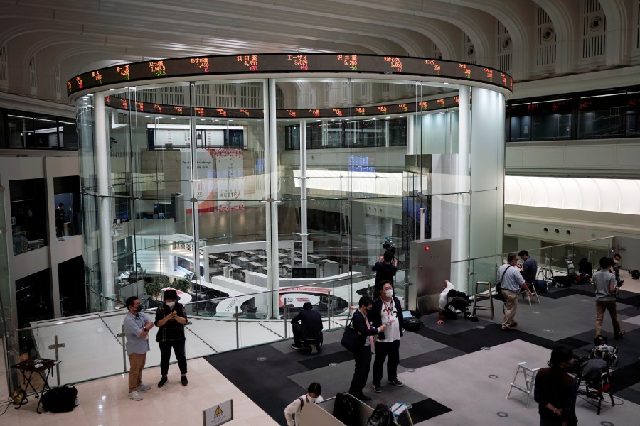 Journalists film an electronic stock board showing reopened Japan's Nikkei 225 index at Tokyo Stock Exchange on Oct. 2, 2020. (AP Photo/Eugene Hoshiko)