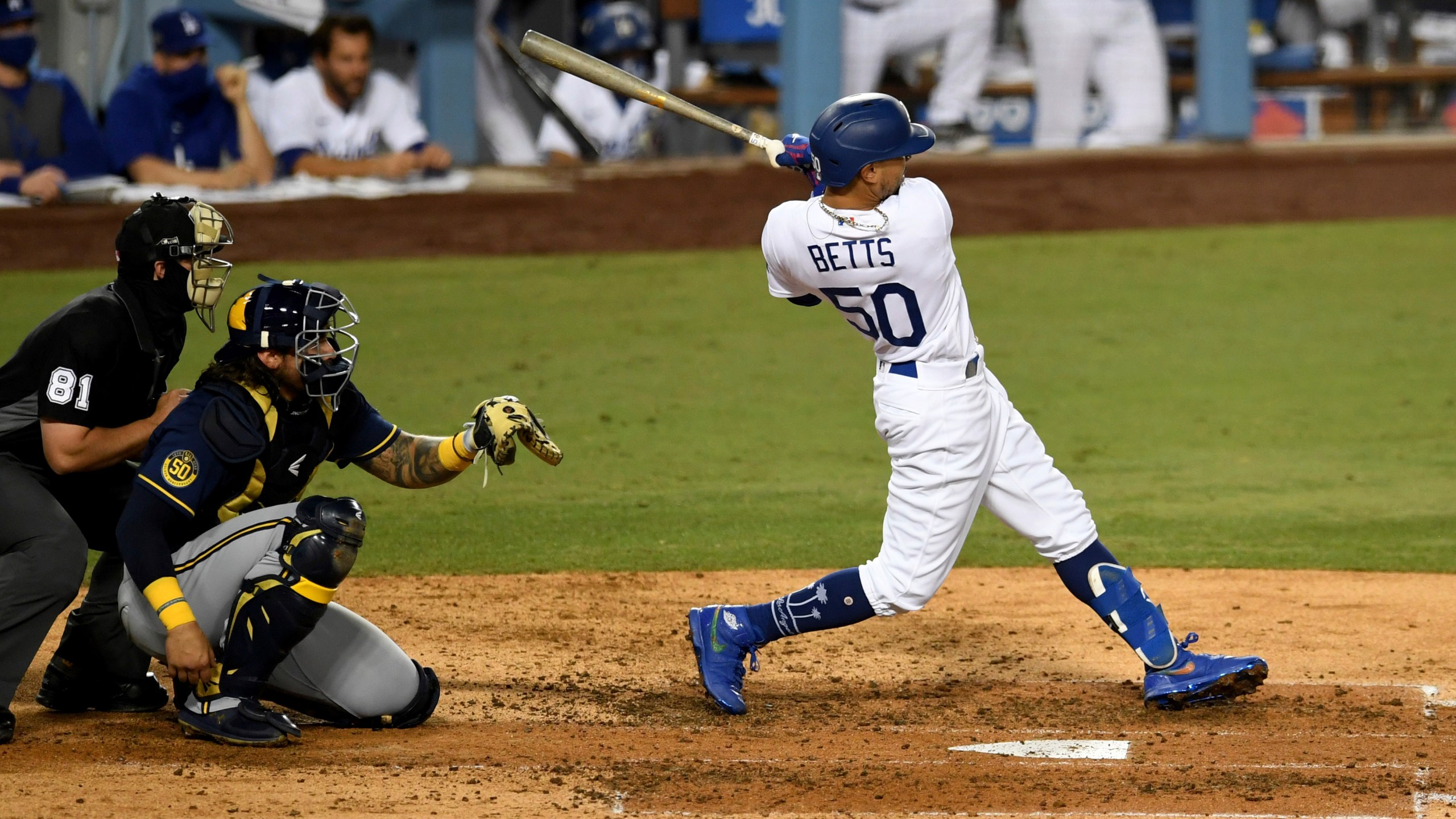 Mookie Betts #50 of the Los Angeles Dodgers two RBI double against the Milwaukee Brewers in the fifth inning of Game 2 of a National League wild-card baseball series MLB baseball game at Dodger Stadium in Los Angeles on Oct. 1, 2020. (Keith Birmingham/The Orange County Register via AP)