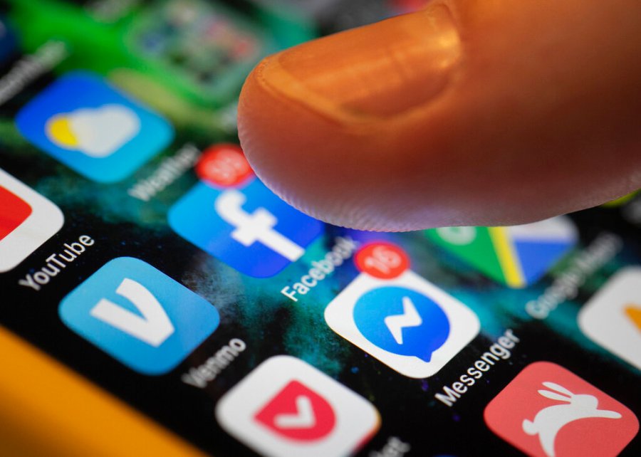 An iPhone displays the apps for Facebook and Messenger in New Orleans on Aug. 11, 2019. (Jenny Kane / Associated Press)