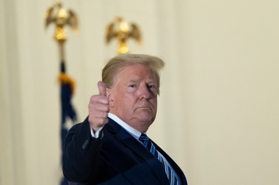 President Donald Trump gives thumbs up from the Blue Room Balcony upon returning to the White House Monday, Oct. 5, 2020, in Washington, after leaving Walter Reed National Military Medical Center, in Bethesda, Md. Trump announced he tested positive for COVID-19 on Oct. 2. (AP Photo/Alex Brandon)