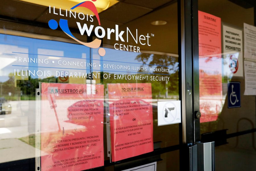 In this June 11, 2020, file photo, information signs are displayed at the closed Illinois Department of Employment Security WorkNet center in Arlington Heights, Ill. (AP Photo/Nam Y. Huh, File)