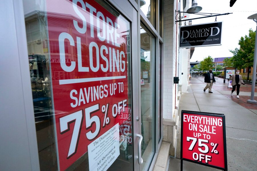 In this Wednesday, Sept. 2, 2020, file photo, passers-by walk past a business storefront with store closing and sale signs in Dedham, Mass. U.S. employers advertised for slightly fewer jobs in August while their hiring ticked up modestly. (AP Photo/Steven Senne, File)