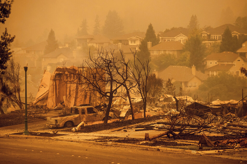 In this Sept. 28, 2020 file photo homes leveled by the Glass Fire line a street in the Skyhawk neighborhood of Santa Rosa, Calif. (AP Photo/Noah Berger, File)