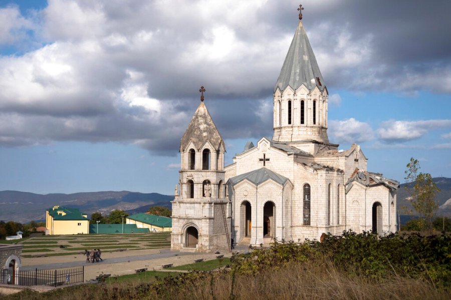 Men carry out furniture from the Holy Savior Cathedral damaged by shelling during a military conflict, in Shushi, outside Stepanakert, self-proclaimed Republic of Nagorno-Karabakh on Oct. 8, 2020. (AP Photo)