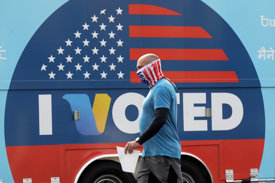 In this May 12, 2020 file photo, Robb Rehfeld wears a mask as he walks to cast his vote during a special election for California's 25th Congressional District seat in Santa Clarita, Calif. (AP Photo/Marcio Jose Sanchez, File)