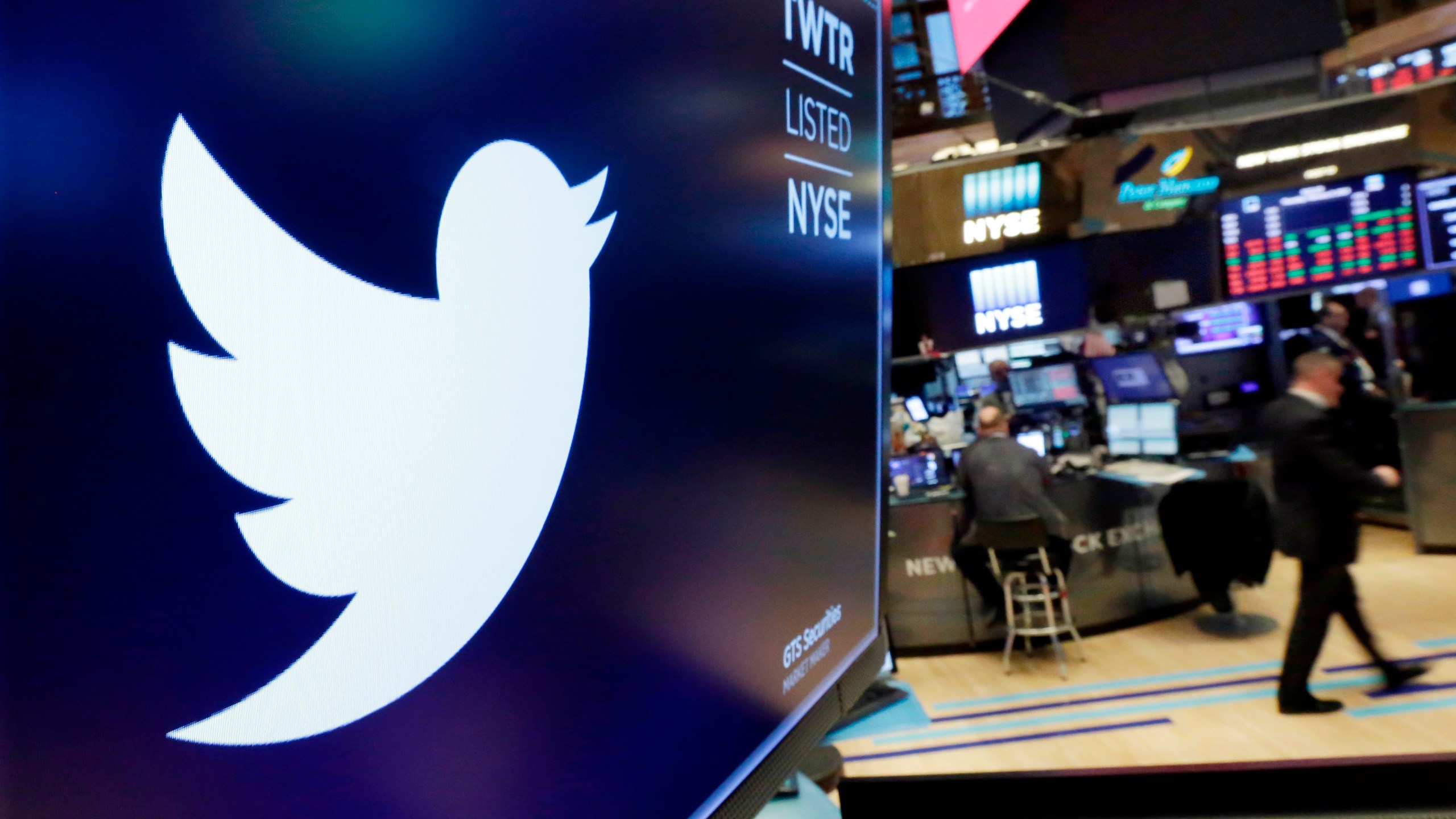 In this Feb. 8, 2018, file photo, the logo for Twitter is displayed above a trading post on the floor of the New York Stock Exchange. Twitter is imposing new rules, Friday, Oct. 9, 2020, ahead of the U.S. presidential election, prohibiting people, including candidates, from claiming an election win before it is called by either state election officials or two authoritative, national news outlets. (AP Photo/Richard Drew, File)