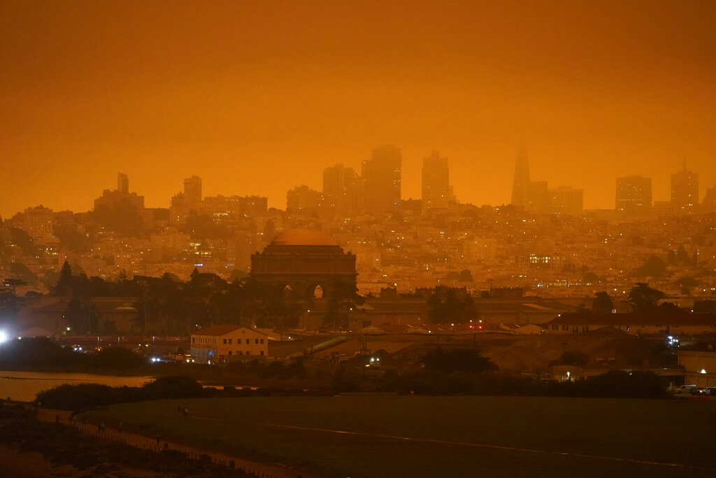 In this Sept. 9, 2020, file photo, taken at 11:18 a.m., is a dark orange sky above Crissy Field and the city caused by heavy smoke from wildfires in San Francisco. (AP Photo/Eric Risberg, File)