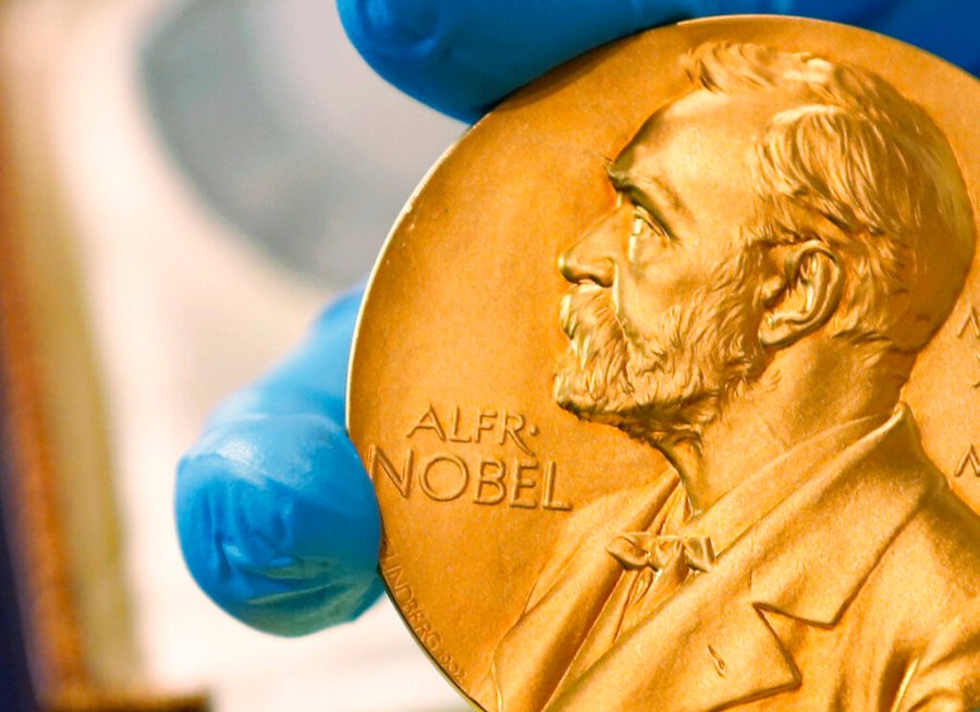 In this April 17, 2015 file photo shows a gold Nobel Prize medal. Americans Paul R. Milgrom and Robert B. Wilson have won the Nobel Prize in economics for "improvements to auction theory and inventions of new auction formats." it was announced Monday Oct. 12, 2020. (AP Photo/Fernando Vergara, File)