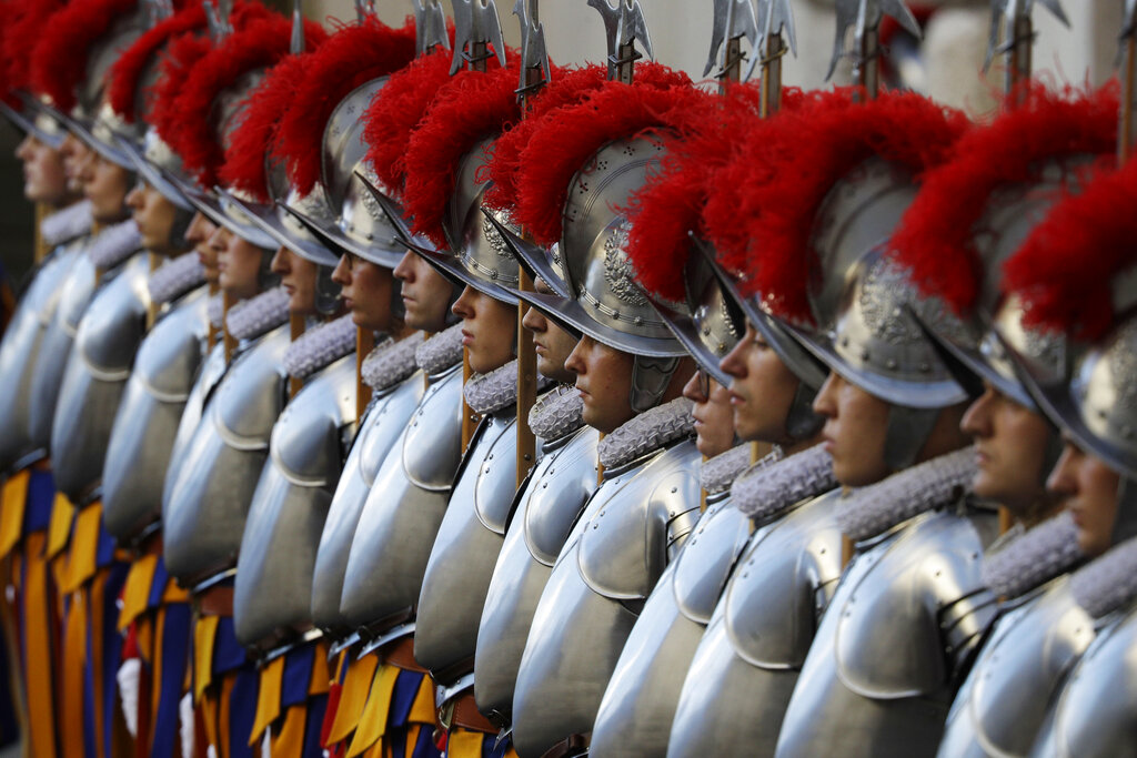 In this Oct. 4, 2020 file photo, Vatican Swiss Guards stand attention at the St. Damaso courtyard on the occasion of their swearing-in ceremony, at the Vatican, Sunday, Oct. 4, 2020. (AP Photo/Gregorio Borgia, file)