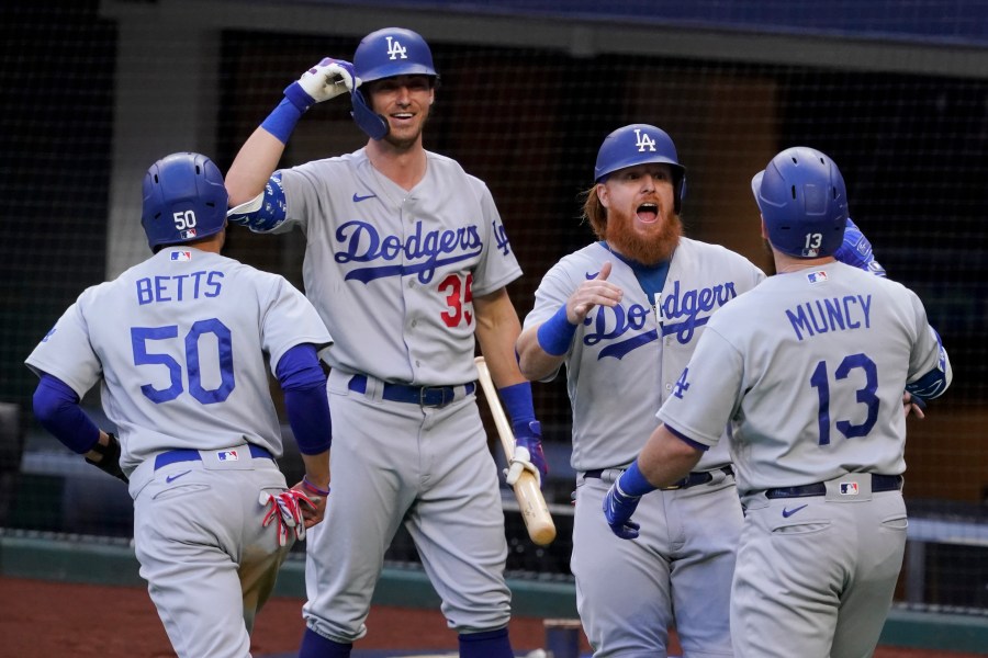 Los Angeles Dodgers' Max Muncy (13) celebrates his grand slam home run during the first inning in Game 3 of a baseball National League Championship Series against the Atlanta Braves on Oct. 14, 2020, in Arlington, Texas. (AP Photo/Tony Gutierrez)